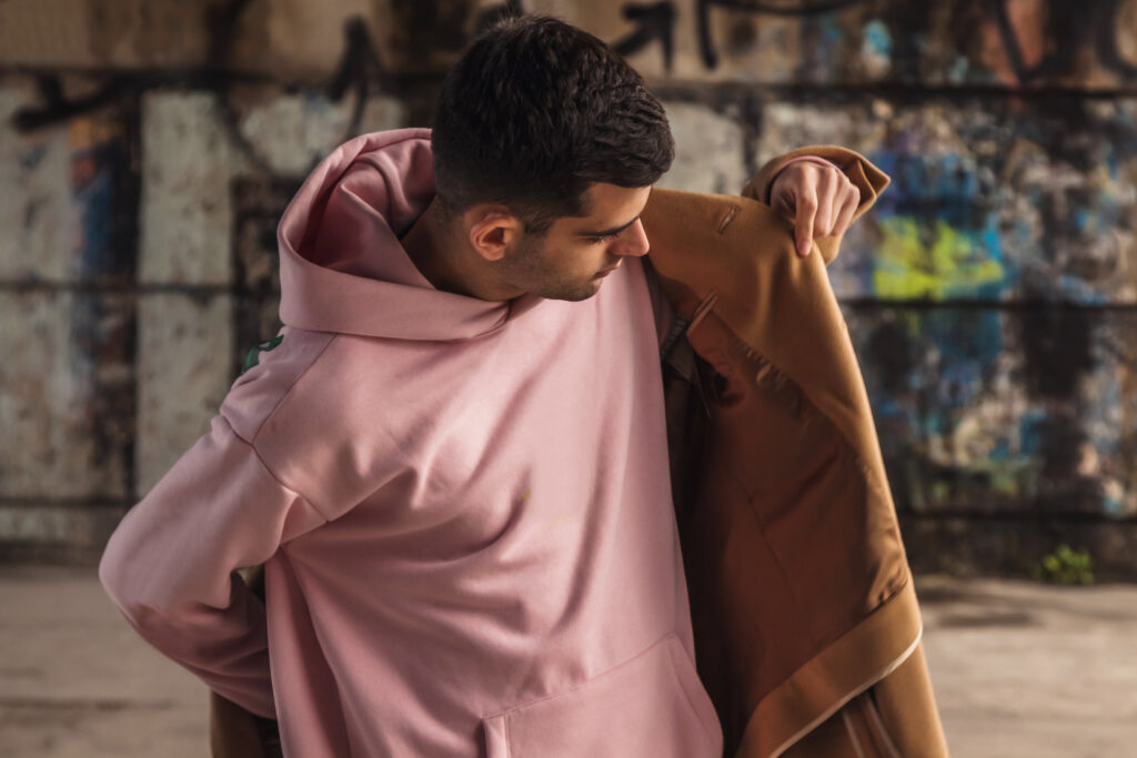 man putting on his coat